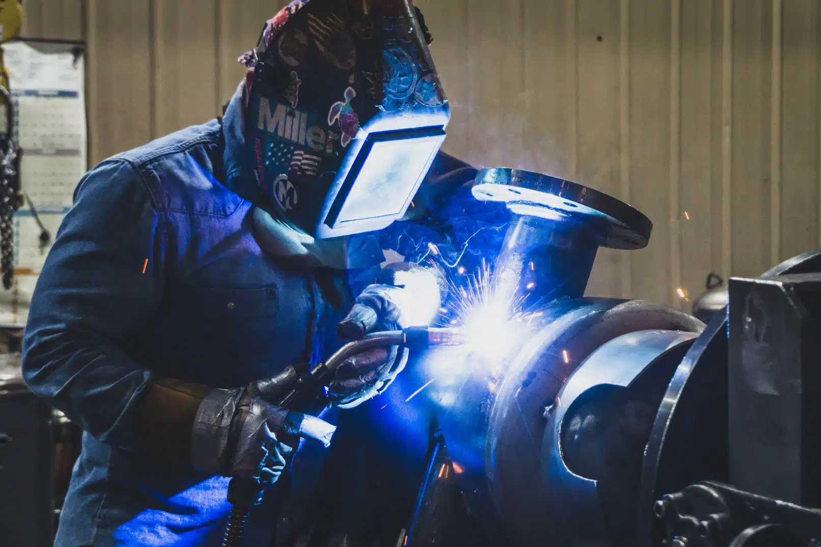 welder working on machinery